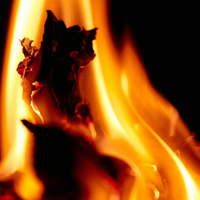 Flames blaze brightly in the darkness, illuminating the night with a fierce, mesmerizing glow