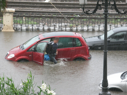 Cars trapped in floodwaters as people struggle to escape during severe flooding in Italy