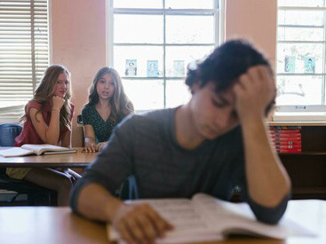 At school, two women talk about a male student who often keeps to himself and appears lonely
