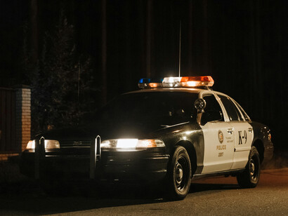 A police car parked beside the crime scene