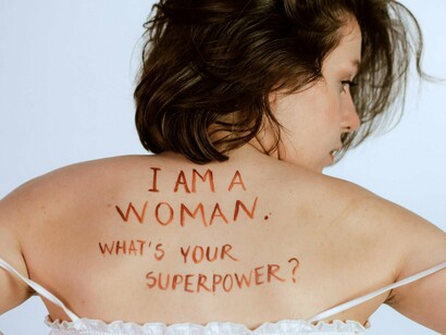 A woman with the message on her back, reflecting the untapped economic power women carry every day