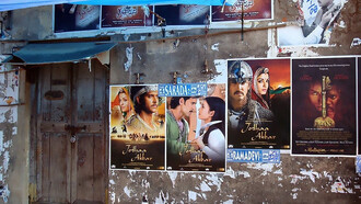 A building covered with colorful movie posters