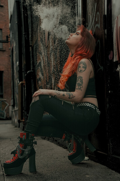 Rebellious youth fashion: a tattooed woman with dyed hair in a crop top