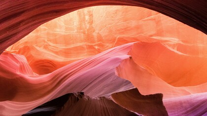 Sculpted by time, the canyon glows in pinks and oranges, nature’s own watercolor painting in motion