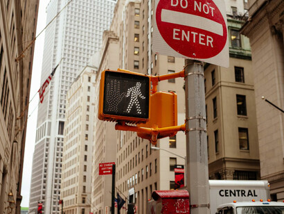 A traffic light and street sign standing side by side in the heart of New York City, USA