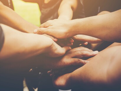 Linked hands representing the global shift from adversaries to allies, building a future grounded in respect