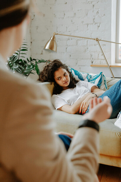 An upset teenage girl listens to her therapist, reflecting the growing mental health struggles faced by Gen Z