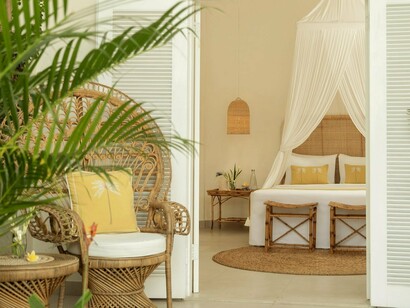 Earth tones, rattan accents, and orchids create an atmosphere of effortless serenity © Photo by Goddess Retreats