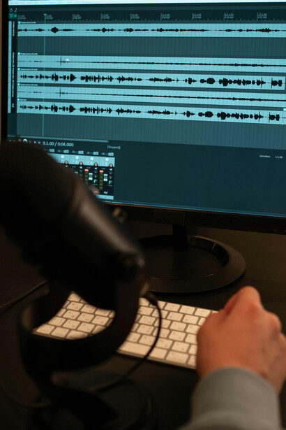 A person pointing at a screen while giving voice commands in an interactive audio installation