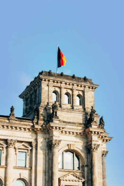 The German flag waves proudly outside the Reichstag in Berlin, Germany