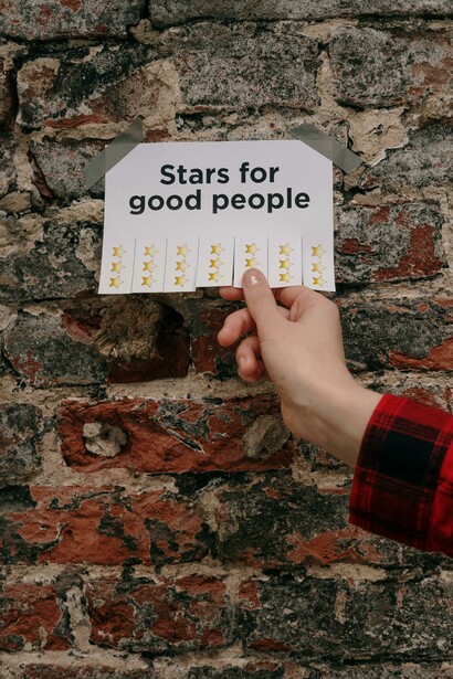 A hand removes a paper star from the wall — motivation through gamification