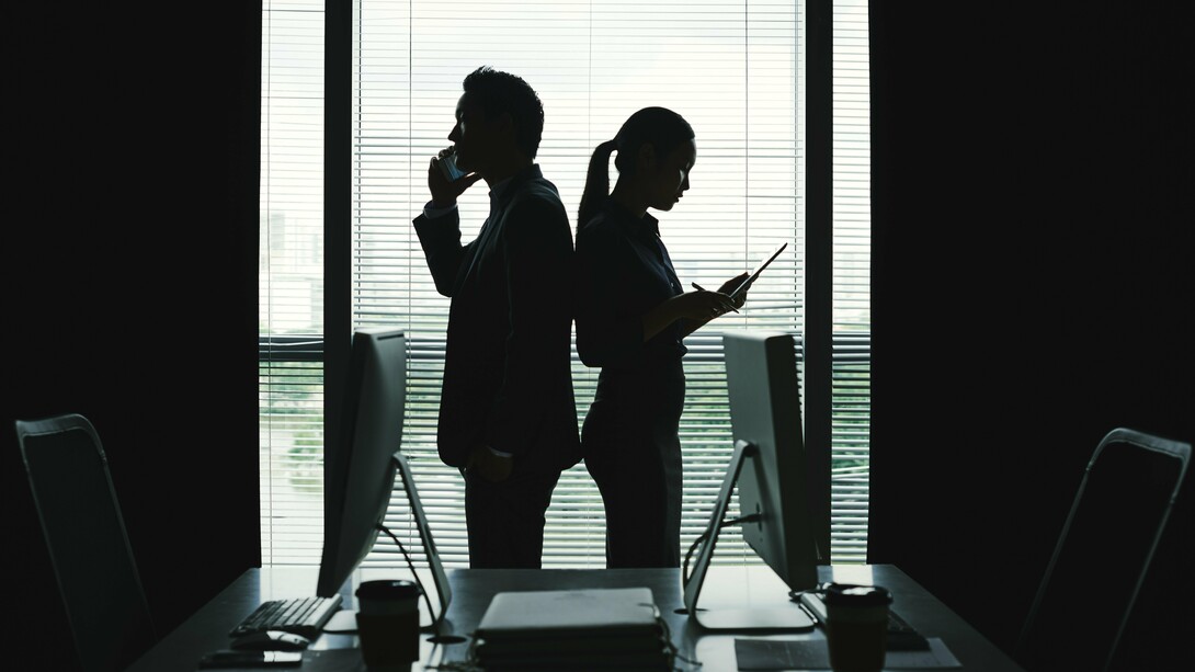 Two figures, one center of gravity: intimacy, image, and power converging behind closed glass