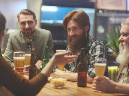 Friends talking and laughing at a bar