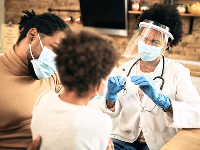 A doctor administering vaccines to a child, highlighting the importance of immunisation in preventing serious illnesses and making it accessible across the continent