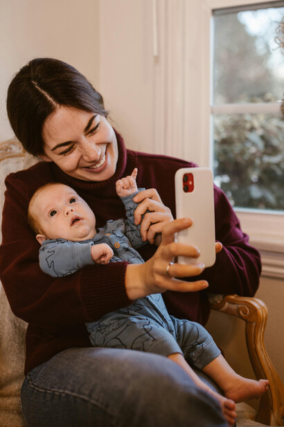 Mother and baby share a family video call, bridging the distance through a tablet screen