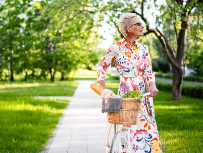 A woman strolling with her bicycle, highlighting the calm that comes from unrushed solitude