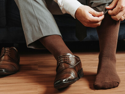 Close-up of a craftsman polishing premium leather shoes, highlighting heritage and durability