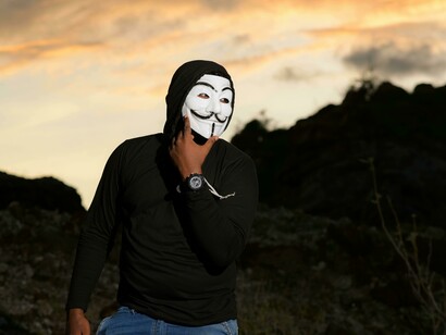 Man wearing a Guy Fawkes mask, symbolizing dissent against political systems