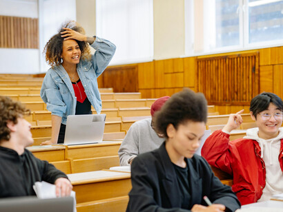Diverse students inside a university classroom, actively engaged in learning