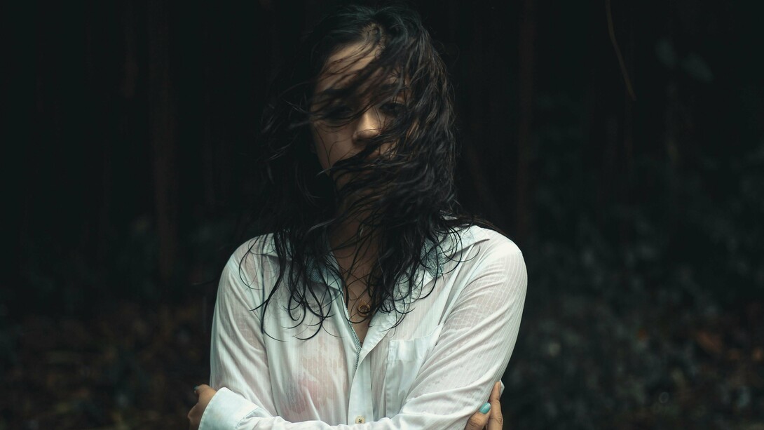 A woman drenched and looking drained, symbolising how some wounds take longer to heal and can pull you under the waves of grief at any moment