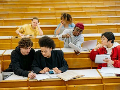 A teacher interacting with a group of students during a class discussion