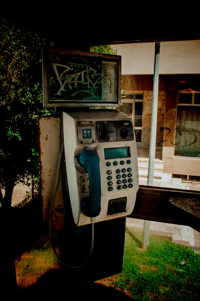 An old telephone booth interior that echoes with the memories of immigrant voices and distant homes