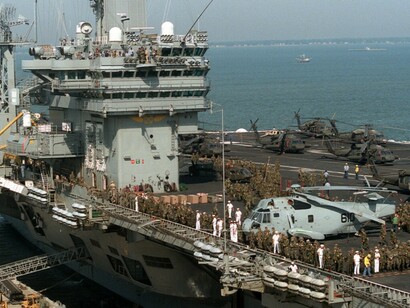 Soldiers from the U.S. Army’s 10th Mountain Division, based at Fort Drum, New York, gather on the flight deck of the nuclear-powered aircraft carrier USS Dwight D. Eisenhower (CVN-69) as it departs for the Caribbean to support Operations Able Vigil and Support Democracy near Haiti