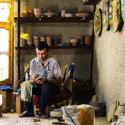 In Gijduvon, Uzbekistan, a skilled potter brings clay to life, hand-decorating ceramics in a centuries-old artistic tradition