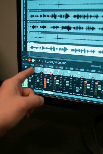 A person interacting with a screen through voice commands as part of a sound installation