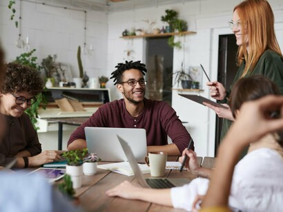 A team of young adults exchanging ideas, echoing the article’s theme of youth-driven problem-solving