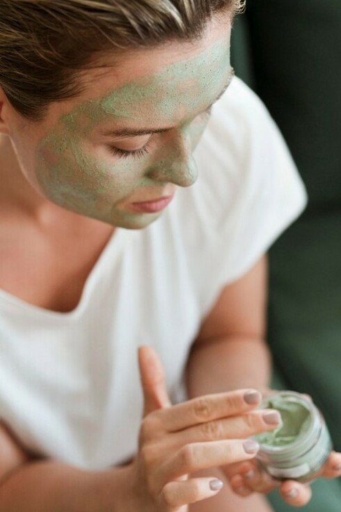 A woman uses an organic facial mask to help treat acne and maintain healthy skin