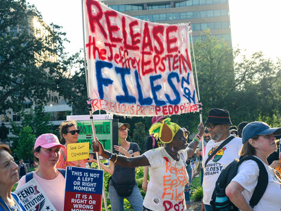 A protester showing a sign that demands the Epstein Files be released