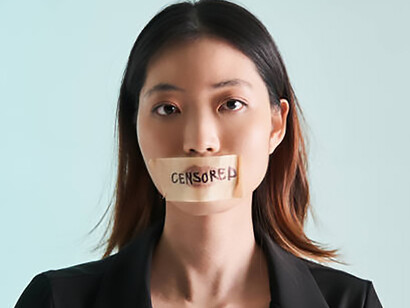 With her mouth sealed by tape and plaster, the woman becomes a stark metaphor for silenced voices and threatened freedom of expression