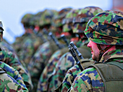 Des soldats pendant un discours, symbolisant le sacrifice d'hommes et de femmes courageux prêts à protéger leur nation