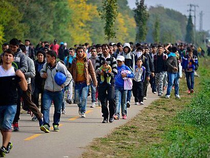 Refugees, with small children and families, making their way to safety