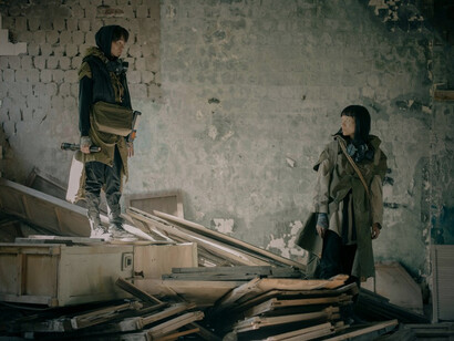 A man and a woman navigating a post-apocalyptic setting, symbolizing resilience in the face of uncertainty and loss