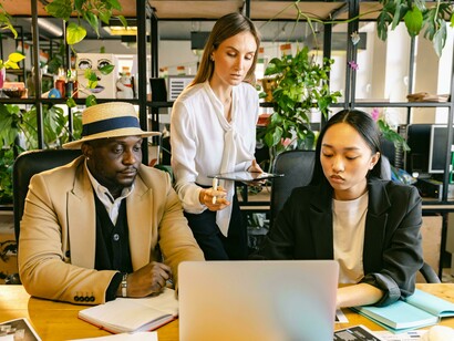 Team members collaborate around a table in a modern, inclusive workplace