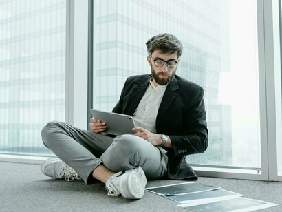 A young professional sits in a high-rise office, disconnected from traditional ambition