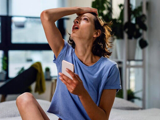 Social media notifications flood the woman's screen, amplifying anxiety and interrupting her peace of mind