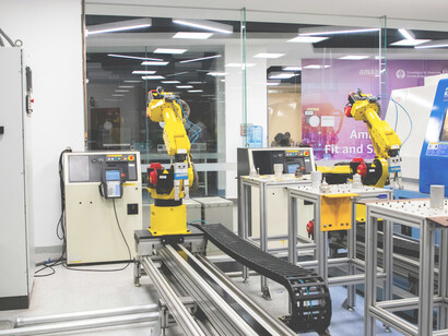 Robots are actively working alongside machines in a factory, illustrating the seamless collaboration between automation and advanced manufacturing systems