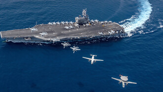 South China Sea (Oct. 9, 2019), Aircraft from Carrier Air Wing (CVW) 5 fly in formation over the forward-deployed aircraft carrier USS Ronald Reagan (CVN 76), flagship of Carrier Strike Group 5