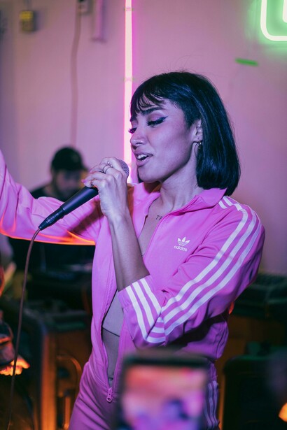 A girl sings karaoke in a bar, turning music into a powerful tool for language learning and cultural immersion