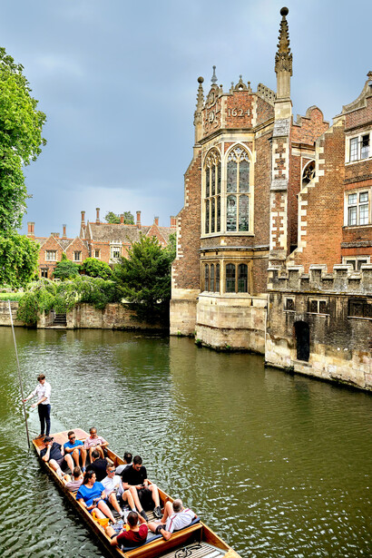 A group of tourists being punted on the River Cam, a popular activity in Cambridge, UK