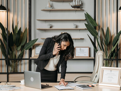 Professional woman at her office desk, symbolizing financial security and personal success in her career