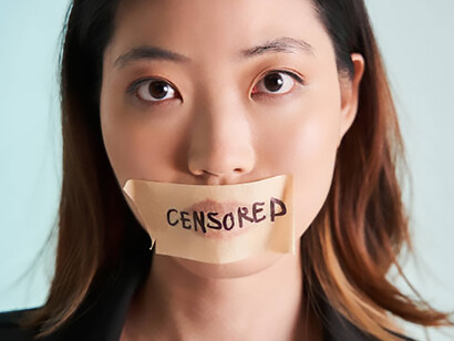 A woman stands in protest, her mouth locked shut with tape and plaster, symbolizing the suppression of free speech