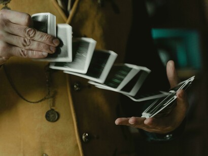 A magician spreading cards in hand, highlighting how illusion can shape what we think is random