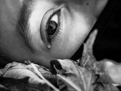 A tear rolling down, signifying how grief can manifest physically and tie us down