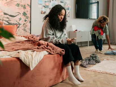 A dejected teen feeling unseen and unheard even with another presence in the room, reflecting it can result in a lack of connection with others and a strong desire for approval