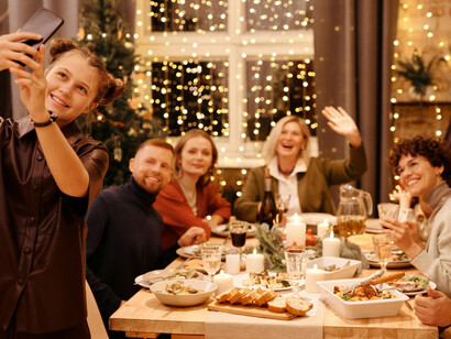 A family enjoying their Christmas dinner and taking a selfie together