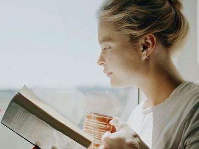 Surrounded by the soft light of the afternoon, the woman revels in the simplicity of an unplugged moment, letting her thoughts wander freely